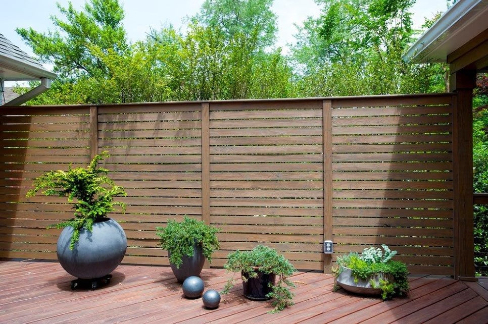 contemporary hardwood privacy fence with plant decorations