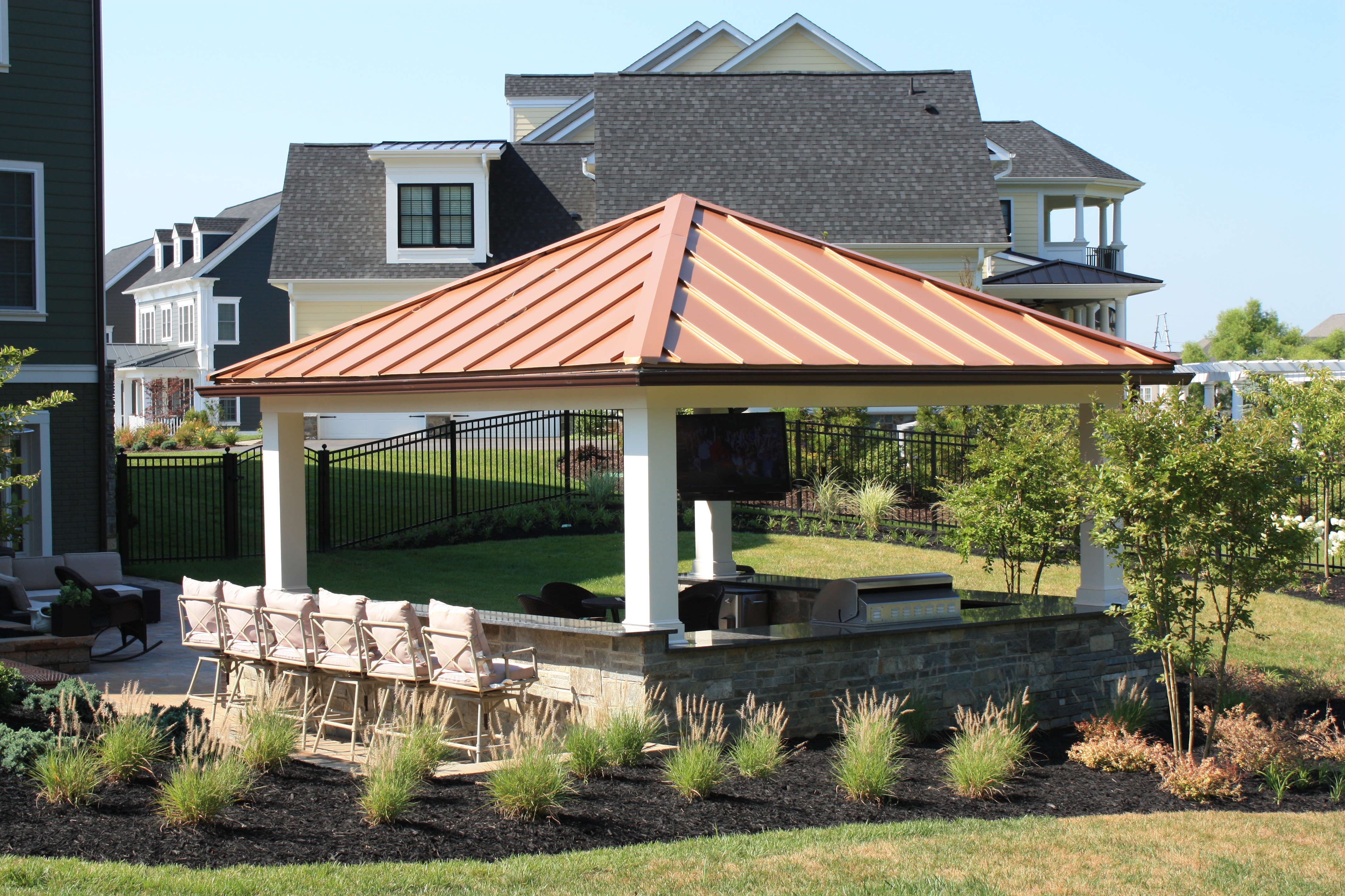 Custom Outdoor Kitchen With Copper Roof And Low Maintenance Deck