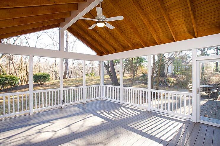 screened-in porch in maryland with wood ceiling and white ceiling fan