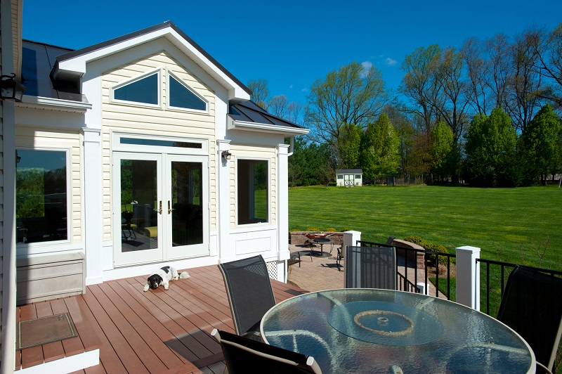 Belgard Patio, Azek Deck, and Sun Room Addition Built in Damascus, Maryland by Design Builders, Inc.