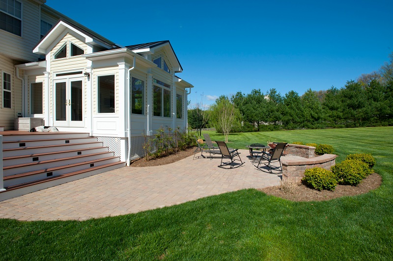 Belgard Patio, Azek Deck, and Sun Room Addition Built in Damascus, Maryland by Design Builders, Inc.