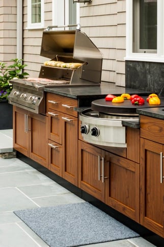 Danver outdoor kitchen cabinets outfitted with backyard cooking and grilling appliances