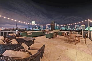 creative rooftop deck with powder coated Danver cabinets in New Orleans, LA at night