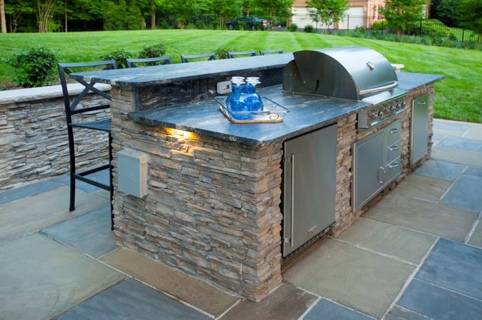 outdoor kitchen island with Blaze grill, trash pull, and stainless steel appliances