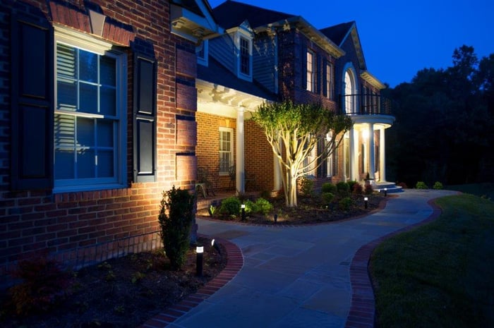 custom front walkway with flagstone and brick pavers at night with outdoor lighting package (1)