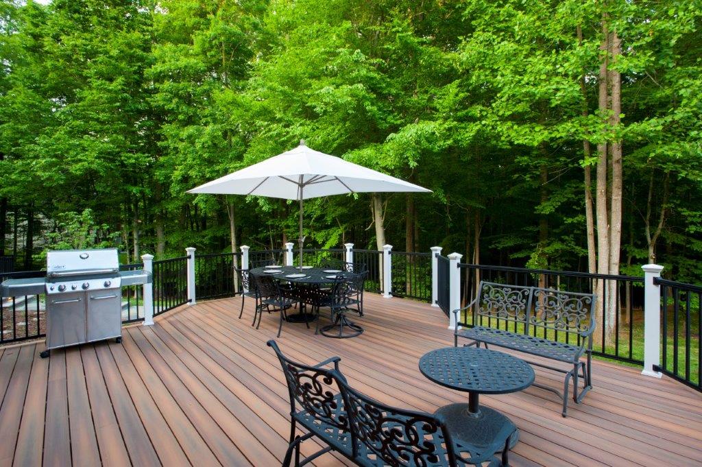 fiberon deck in virginia with black deckorators balusters, iron patio furniture and a stainless steel grill