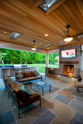 Infratech infrared heaters shown in a covered flagstone patio with Phantom retractable screens in Clifton, Virginia