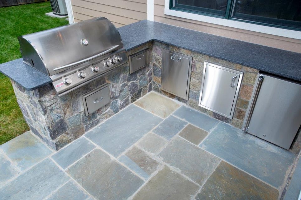 outdoor flagstone kitchen with stainless steel appliances