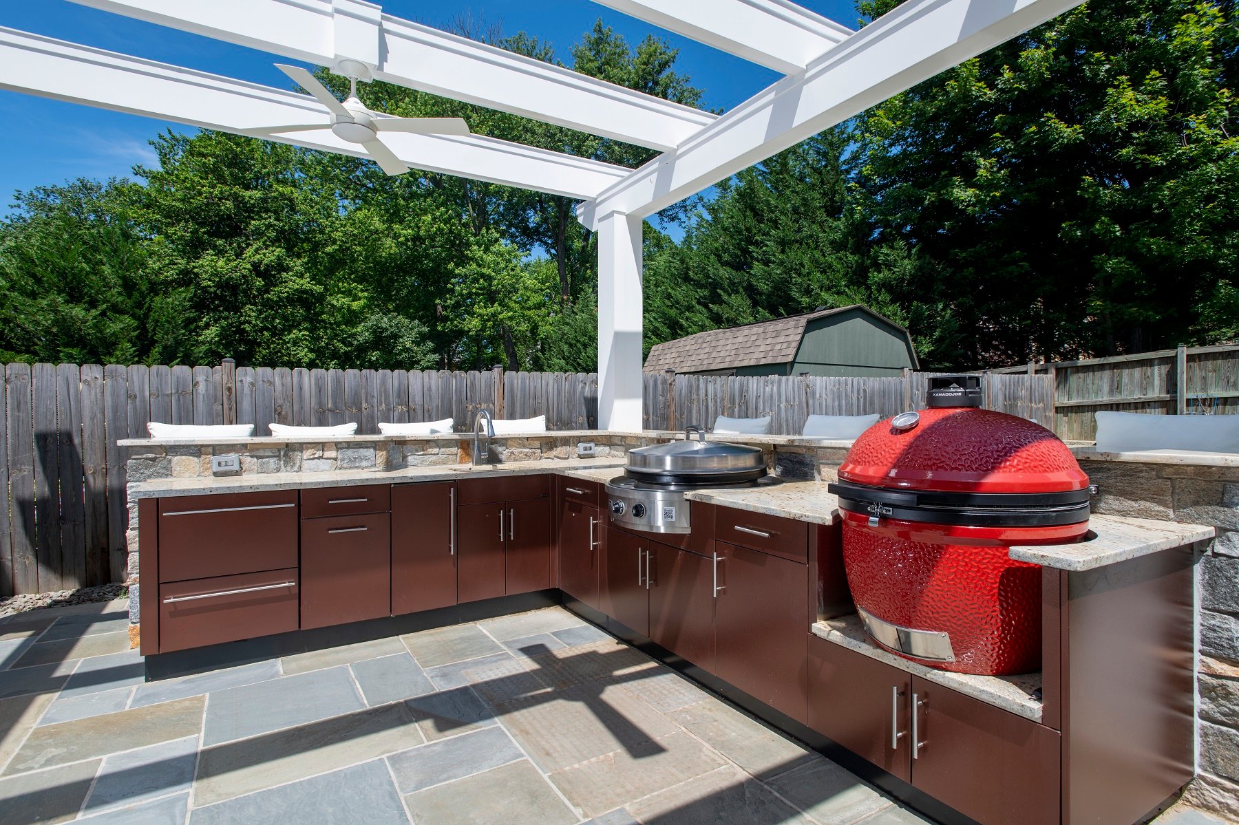 danver outdoor kitchen with white pergola and flagstone patio in bethesda