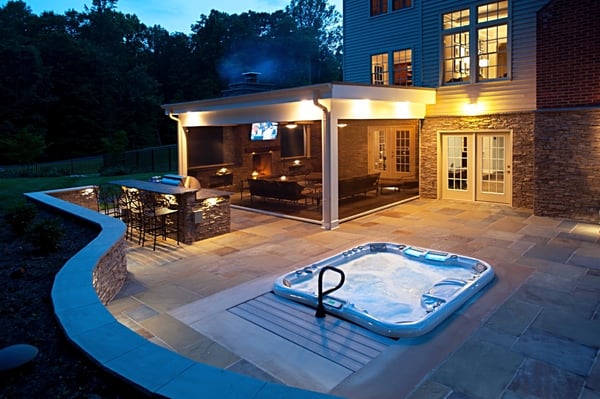 curved-flagstone-patio-at-dusk-with-recessed-hot-tub-clifton-virginia