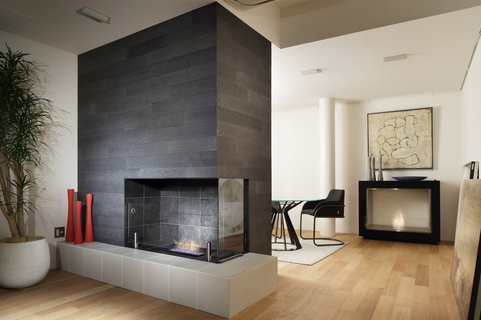 EcoSmart Fire indoor fireplace with black tile, wood floor, and white walls
