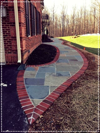 concrete paver patio with brick paver border during construction phase in Clifton, Virginia