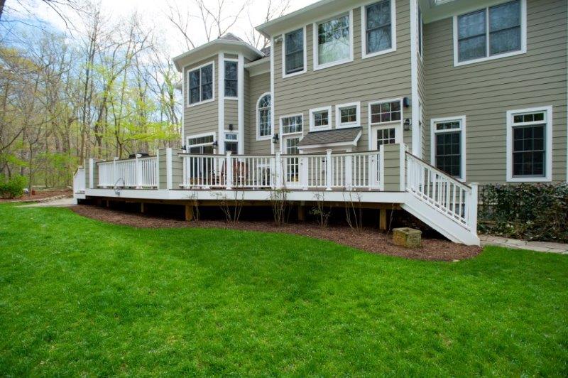 wide shot of deck in Maryland with white PVC trim and Wolf rosewood decking