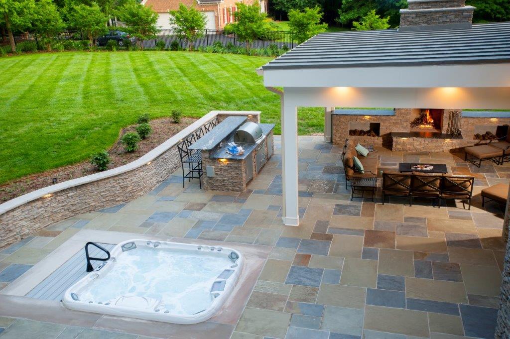 hot tub recessed in custom flagstone patio with curved sitting wall in Clifton, Virginia