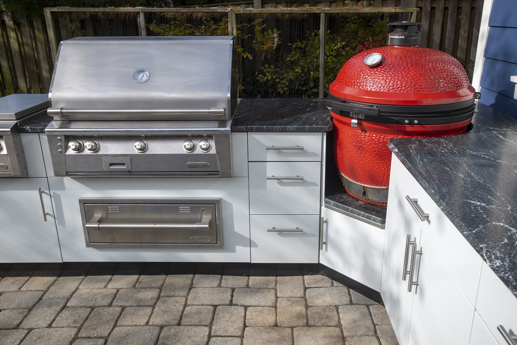 close up of Danver stainless cabinets with green egg smoker, granite countertops and stainless grill