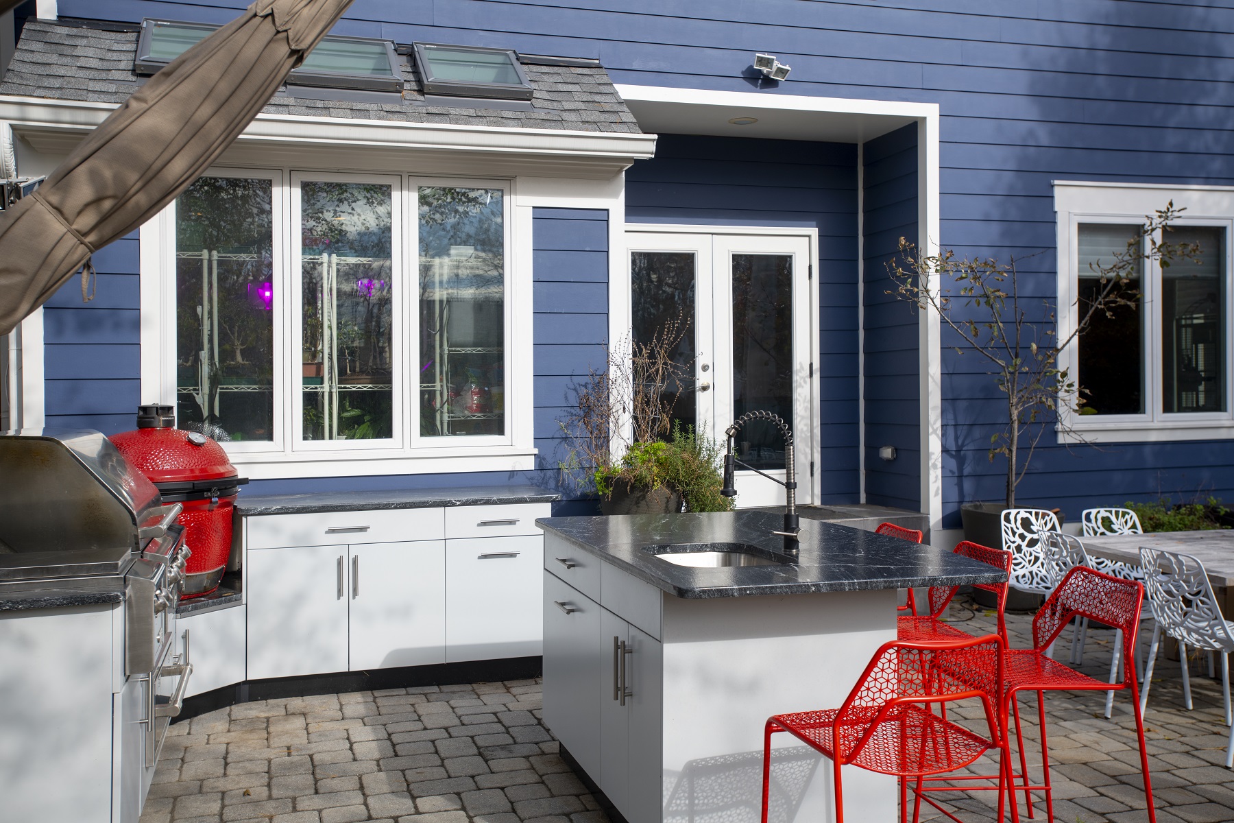 outdoor kitchen design in virginia with white powder coated cabinetry and a red green egg smoker