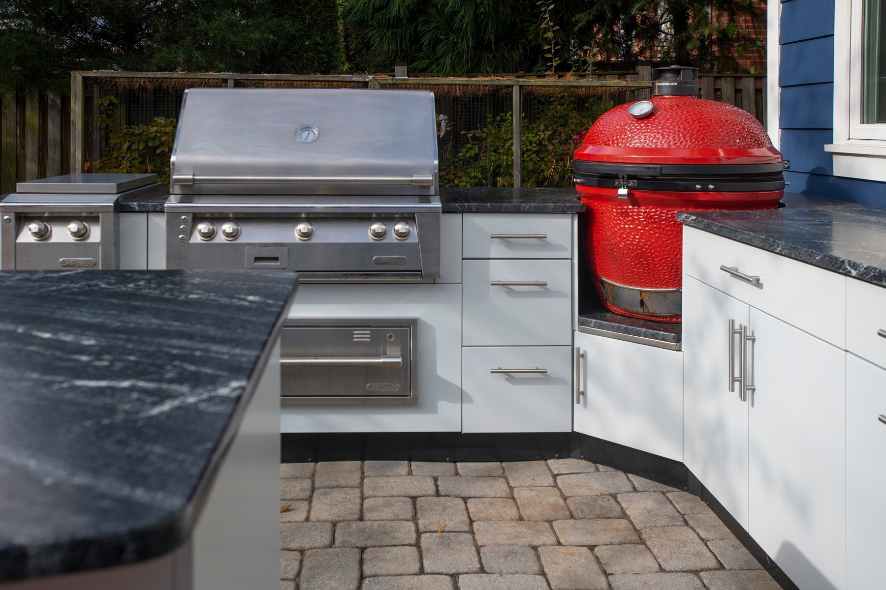 danver outdoor kitchen with green egg smoker, stainless grill, and heating plate